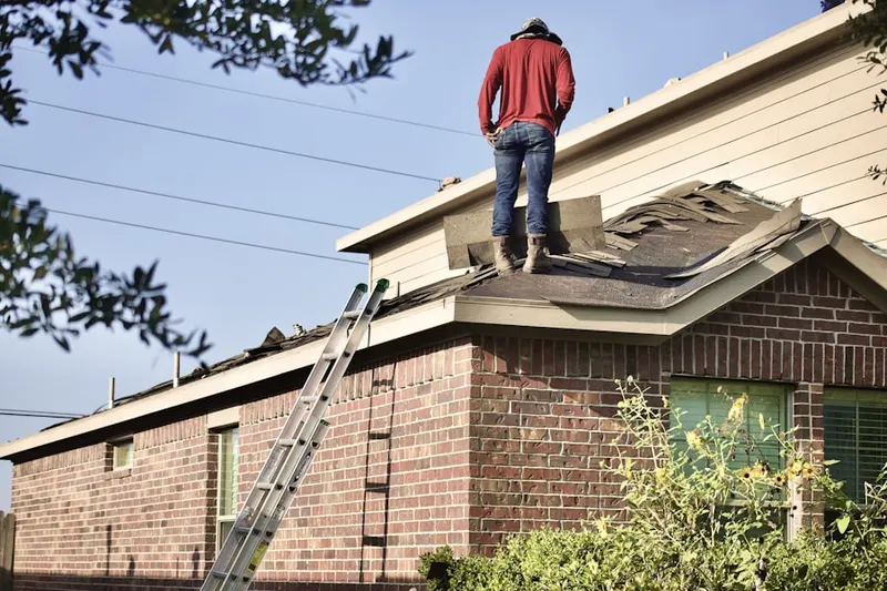 Professional roofer working on a residential roof in Oley